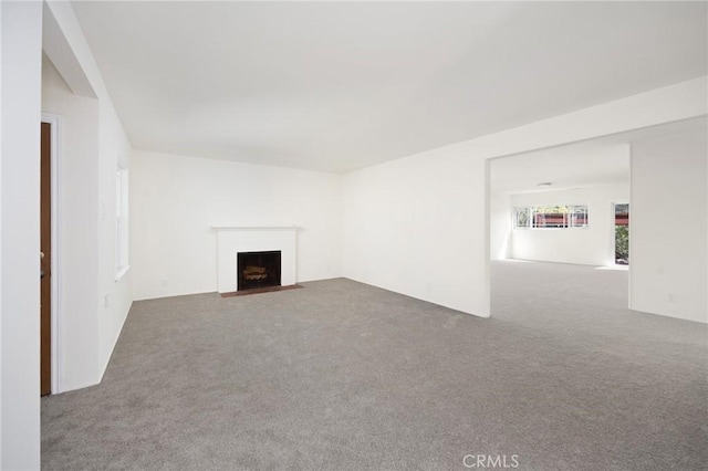 unfurnished living room featuring carpet floors