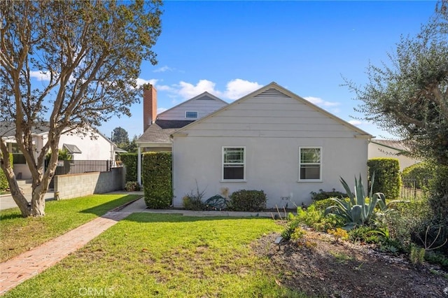 view of side of home featuring a lawn