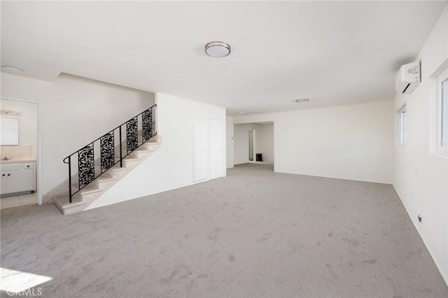 interior space with light carpet and an AC wall unit