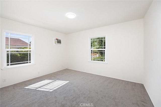 carpeted empty room with a wall mounted AC