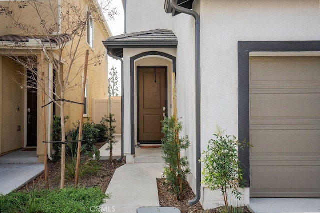 doorway to property with a garage