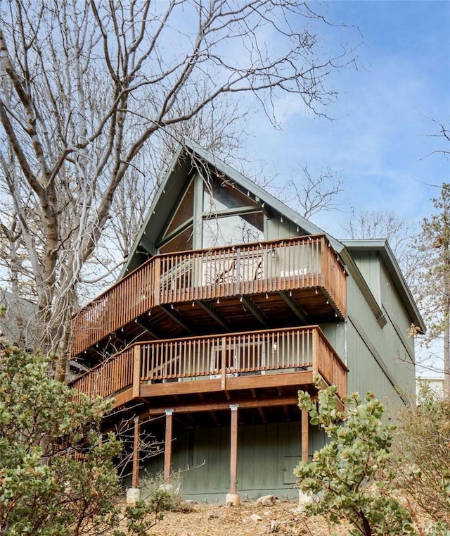 back of house with a wooden deck