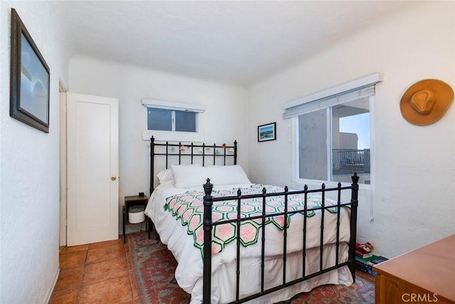 bedroom with dark tile patterned floors