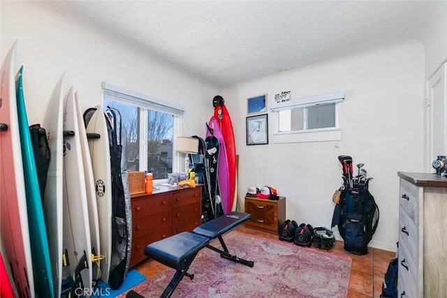 workout room featuring light tile patterned floors