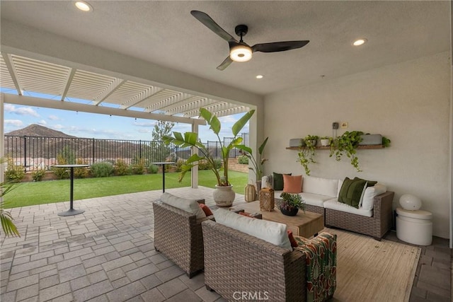 view of patio featuring ceiling fan, an outdoor living space, and a pergola