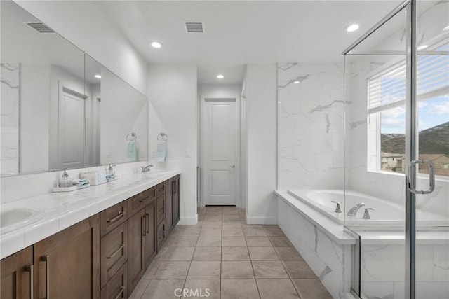 bathroom featuring vanity and separate shower and tub