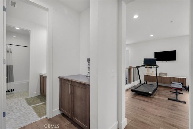 workout room featuring light hardwood / wood-style flooring