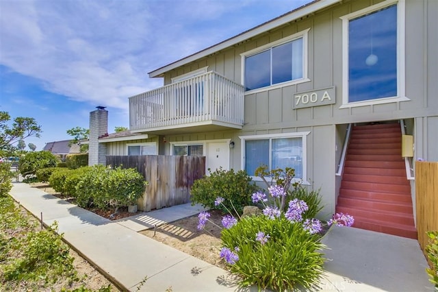 townhome / multi-family property with stairway and board and batten siding