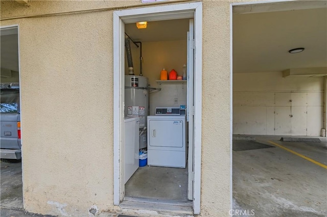 doorway to property with washer and clothes dryer and secured water heater