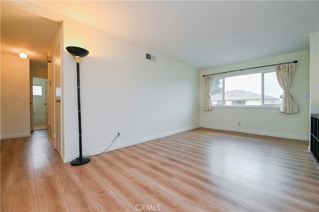 spare room featuring light hardwood / wood-style flooring