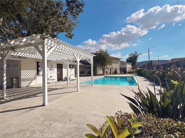 view of pool with a pergola and a patio area