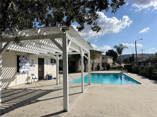 view of swimming pool with a pergola