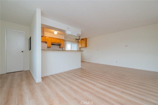 unfurnished living room with ceiling fan and light wood-type flooring