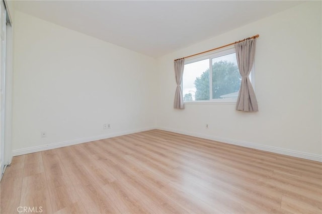 unfurnished room with light hardwood / wood-style floors