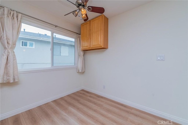 spare room featuring ceiling fan and light hardwood / wood-style flooring