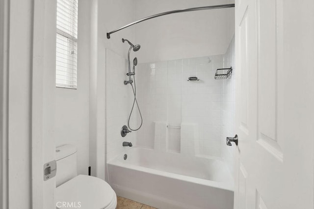 bathroom featuring toilet, tile patterned floors, and bathing tub / shower combination