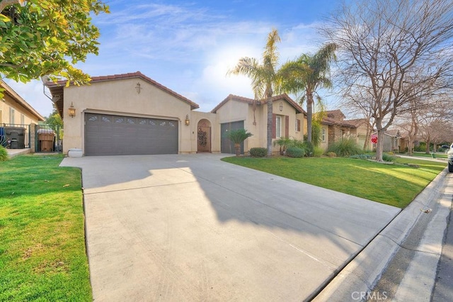 mediterranean / spanish-style house with a garage and a front lawn