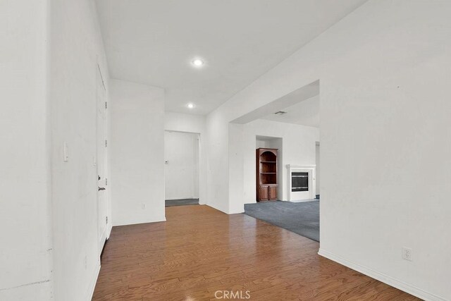 corridor featuring recessed lighting and wood finished floors