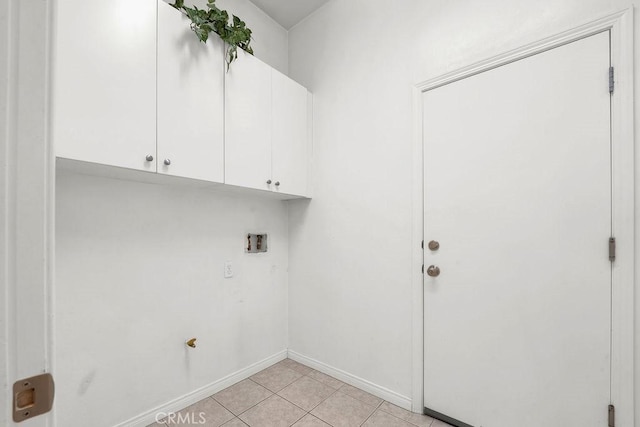 laundry room featuring light tile patterned floors, washer hookup, baseboards, and cabinet space