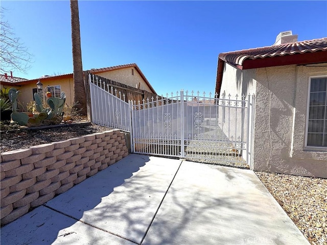 view of patio with a gate and fence
