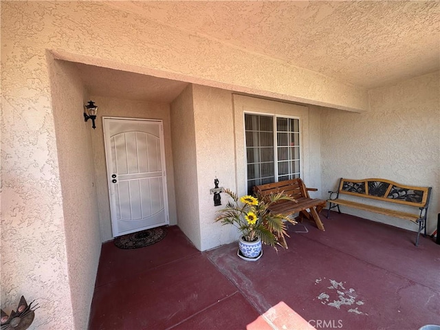 doorway to property with stucco siding