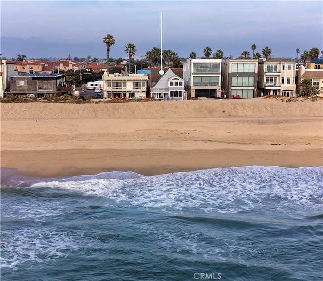 view of yard with a view of the beach and a water view