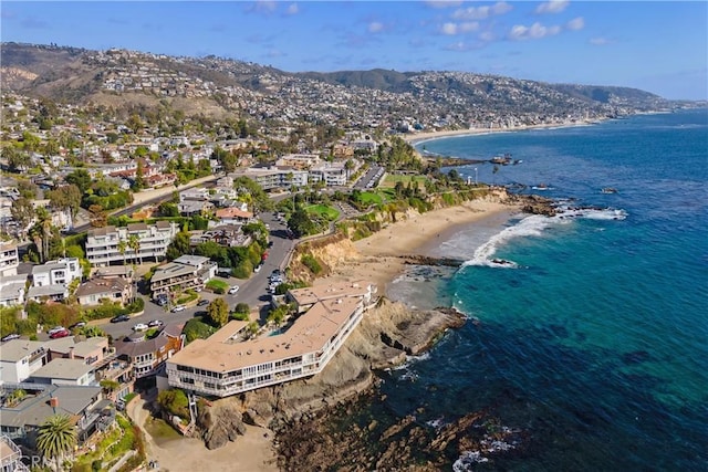 birds eye view of property featuring a view of the beach and a water and mountain view