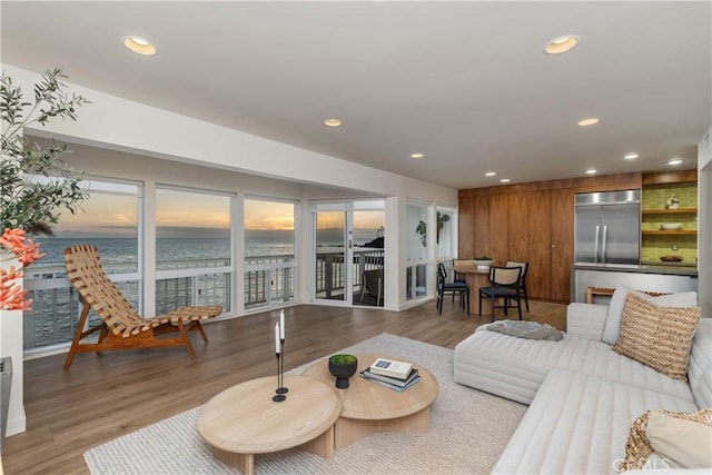 living room featuring a water view and hardwood / wood-style flooring