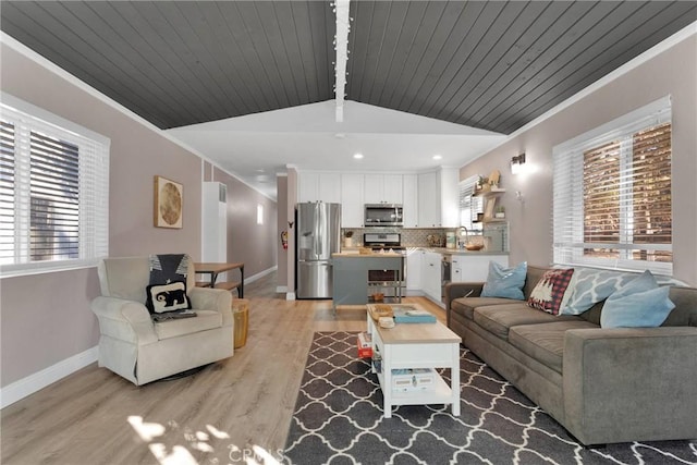 living room with lofted ceiling with beams, crown molding, wood ceiling, and light hardwood / wood-style floors