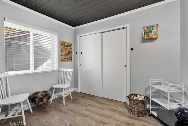 sitting room featuring wood ceiling, ornamental molding, and light hardwood / wood-style floors