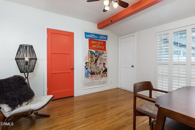 sitting room featuring lofted ceiling with beams, wood-type flooring, and ceiling fan