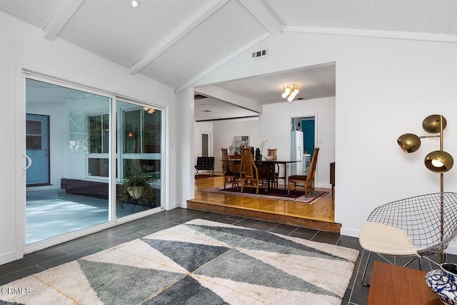 interior space featuring vaulted ceiling with beams