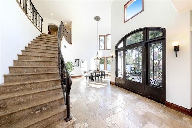 foyer entrance featuring a towering ceiling