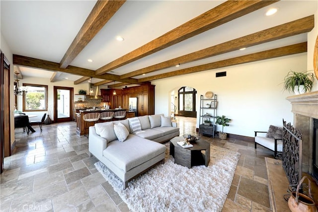 living room featuring a fireplace and beam ceiling