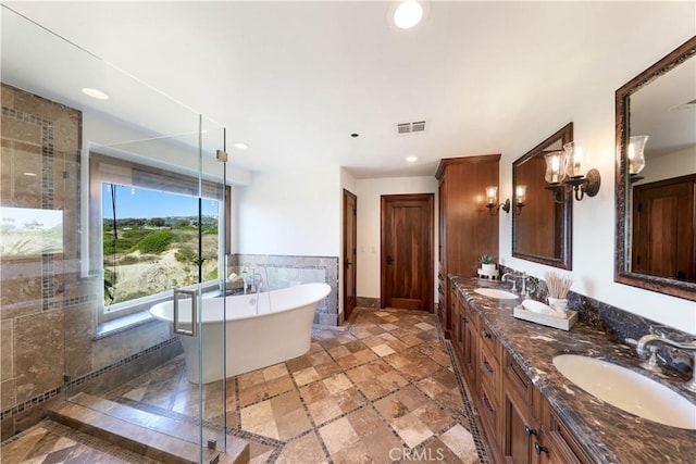 bathroom featuring vanity, tile walls, and plus walk in shower