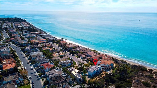 aerial view featuring a water view and a beach view