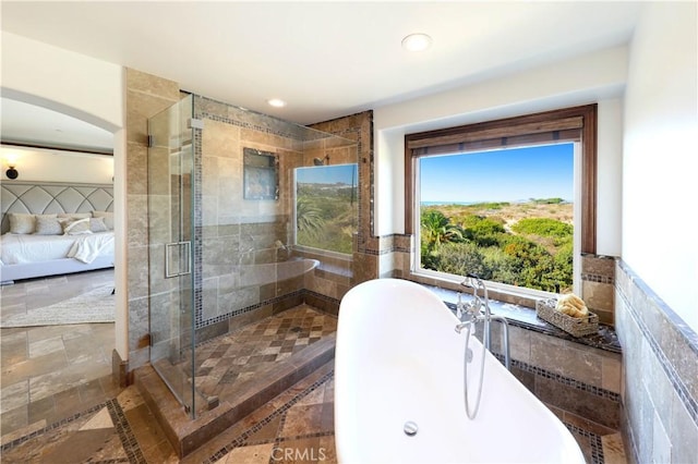 bathroom with plus walk in shower and tile walls