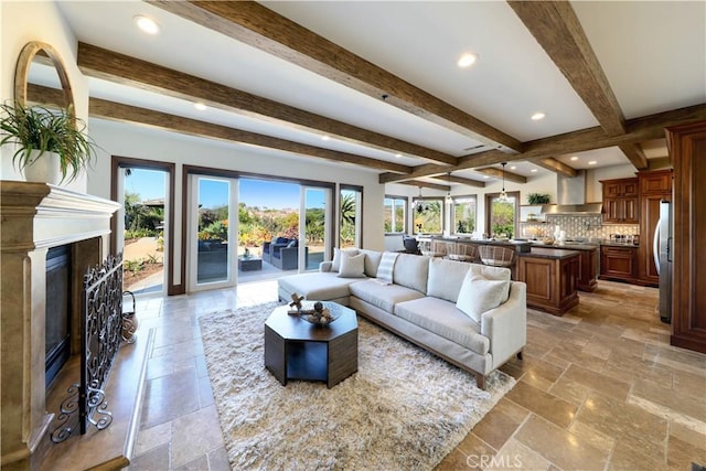 living room with beam ceiling and a fireplace