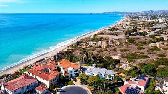 bird's eye view featuring a water view and a beach view