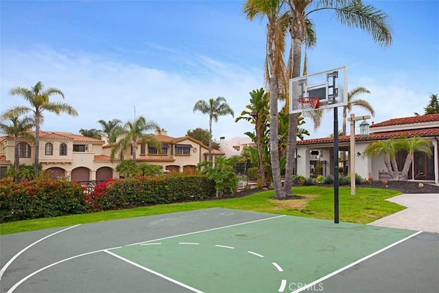 view of sport court with a lawn