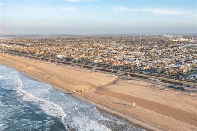 bird's eye view featuring a water view and a beach view