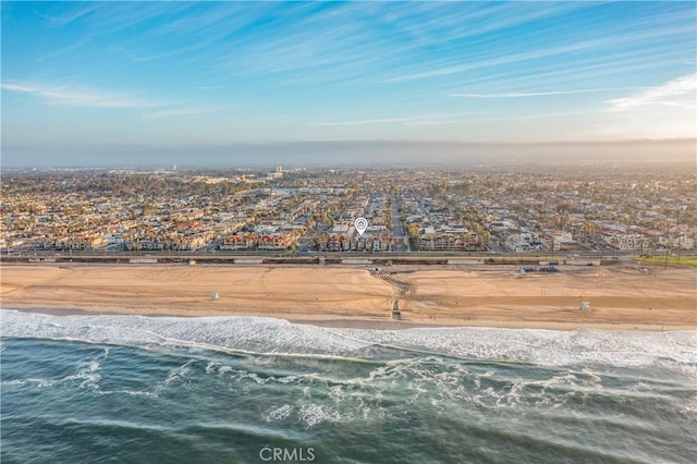 birds eye view of property featuring a water view and a view of the beach