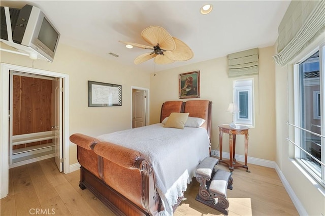 bedroom with ceiling fan and light hardwood / wood-style floors