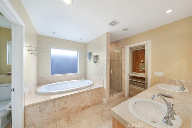 full bathroom with shower with separate bathtub, vanity, and toilet