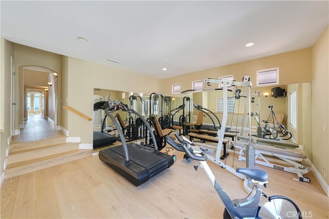 exercise room with light hardwood / wood-style flooring