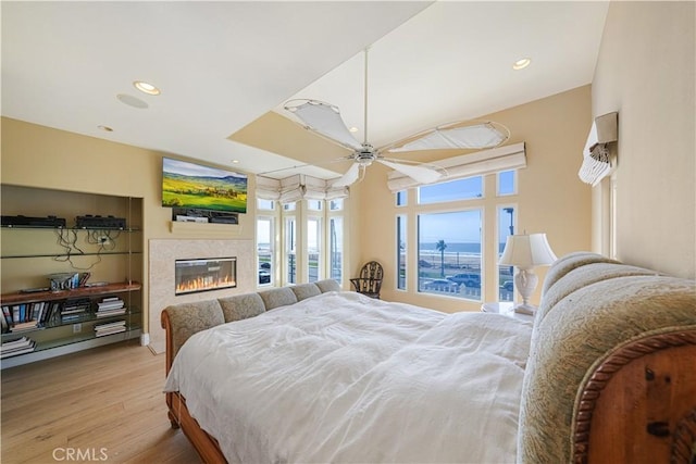 bedroom featuring ceiling fan and light hardwood / wood-style floors