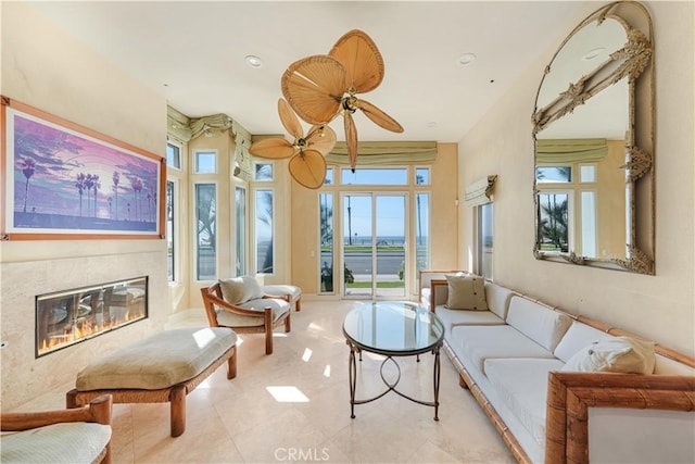 interior space with ceiling fan and a high end fireplace