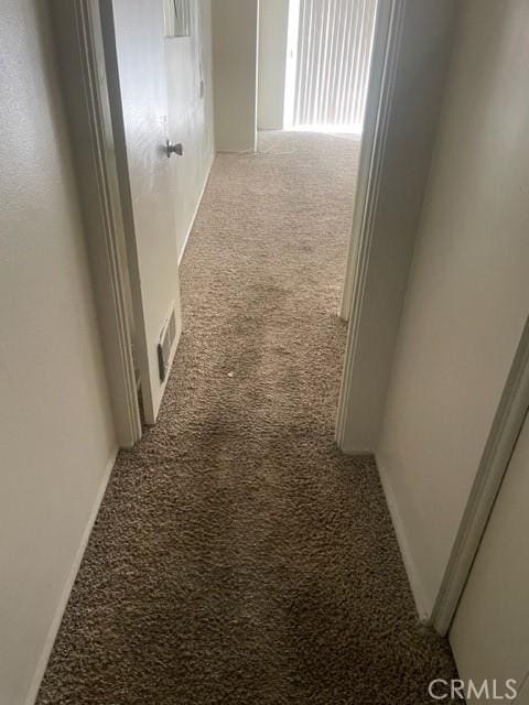 hallway with light carpet and visible vents