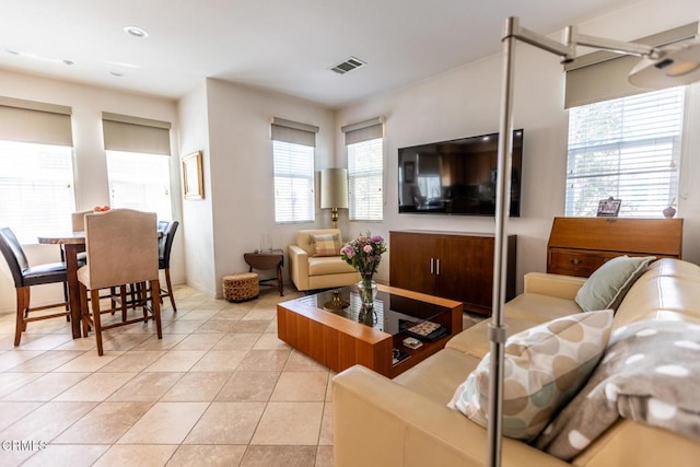 living area featuring light tile patterned floors and visible vents