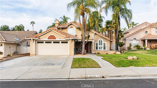 mediterranean / spanish home featuring driveway, a tile roof, an attached garage, a front yard, and stucco siding